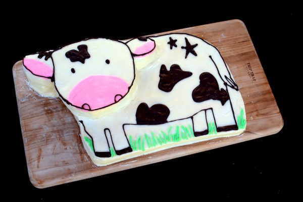 Homemade cow cake with chocolate writing