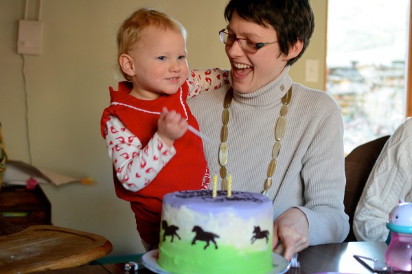 Purple and green horse cake with chocolate writing