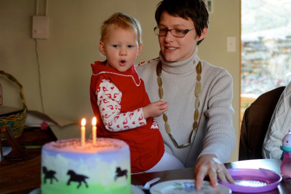 Purple and green horse cake with chocolate writing